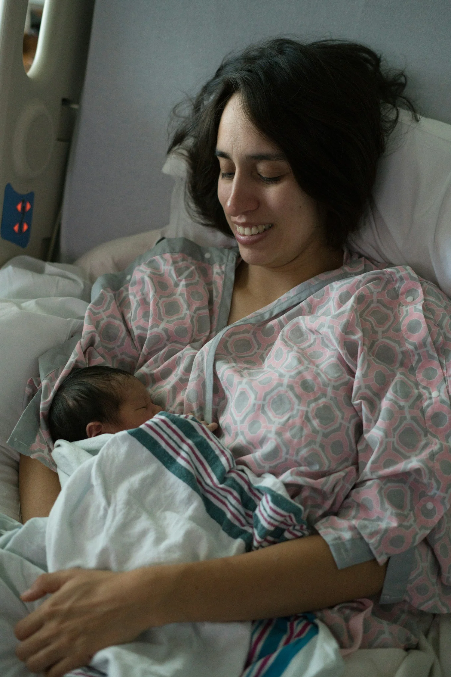 Mother in a hospital bed holding her newborn