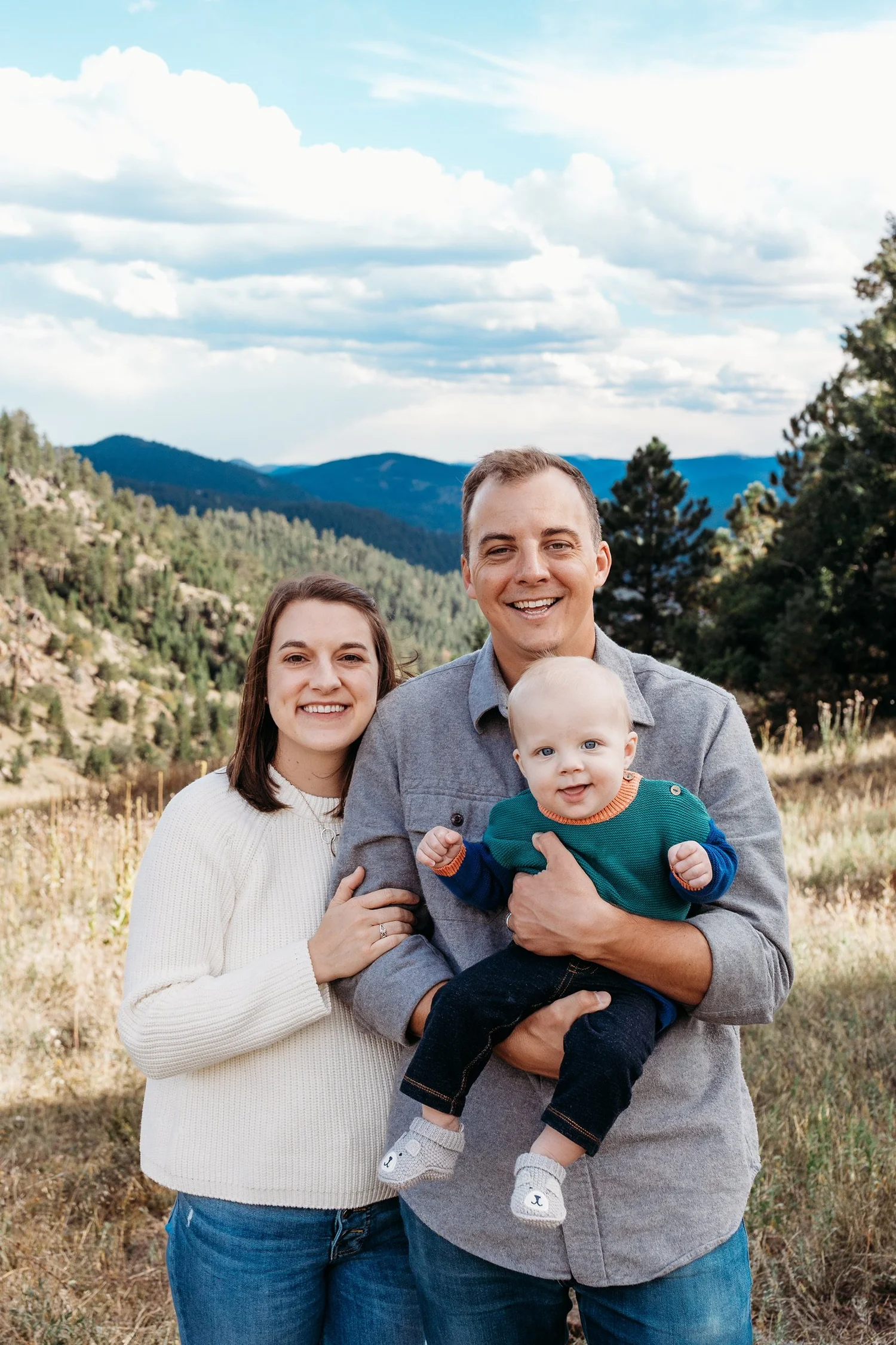 The Pigott family outdoors with mountains in the background